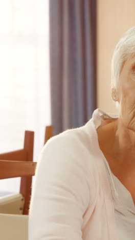 Unhappy-senior-woman-sitting-alone