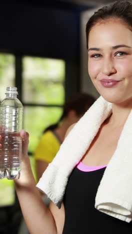 Happy-brunette-drinking-water