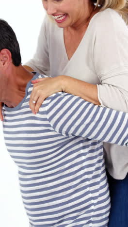 Happy-man-giving-piggybag-to-woman-against-white-background