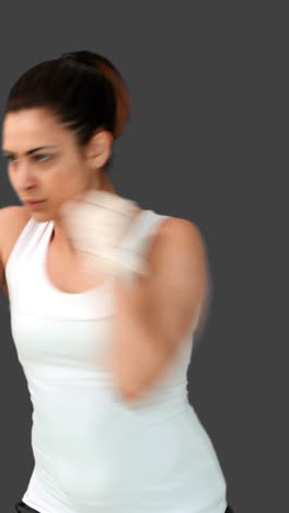 Fit-brunette-punching-with-bandaged-fists