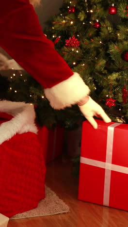 Santa-delivering-gifts-under-christmas-tree