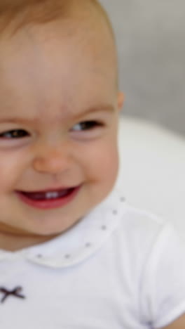 Cute-baby-girl-playing-with-towel-on-bed