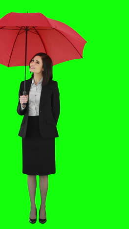 Businesswoman-standing-under-umbrella-