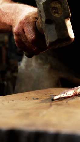 Mid-section-of-blacksmith-working-on-a-iron-rod