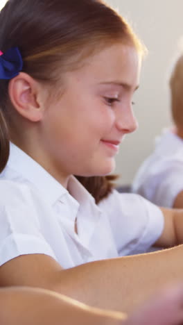 School-kids-using-digital-tablet-in-classroom