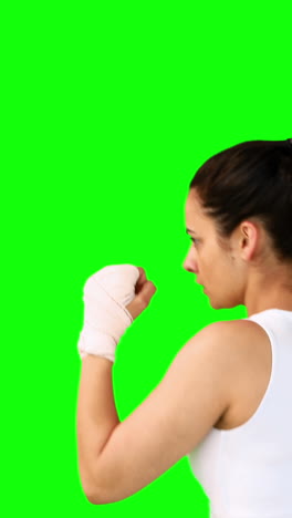 Fit-brunette-punching-with-bandaged-fists