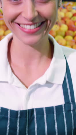 Female-staff-holding-fresh-green-apples-in-wicker-basket