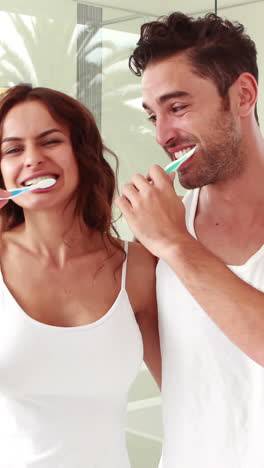 Happy-couple-brushing-teeth