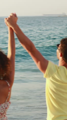 Five-friends-hand-in-hand-standing-at-the-beach