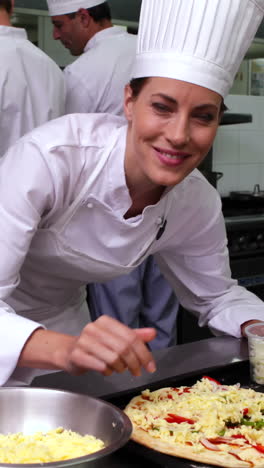 Happy-pretty-chef-preparing-a-pizza