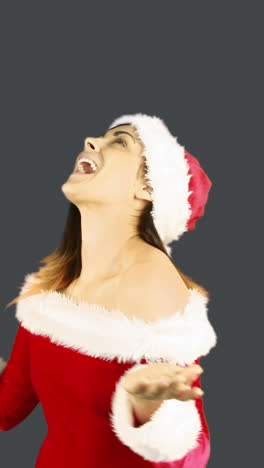 Joyful-santa-girl-looking-up-and-smiling-at-camera