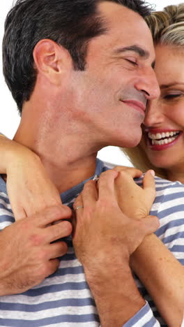 Happy-young-couple-embracing-each-other-against-white-background