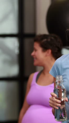 Fit-woman-smiling-at-camera-in-gym