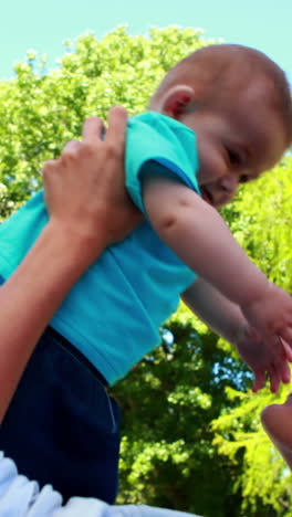 Happy-mother-playing-with-her-cute-baby-son