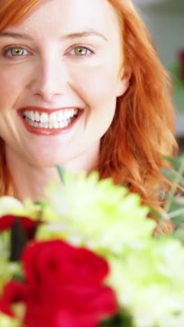 Female-florist-holding-bunch-of-flowers