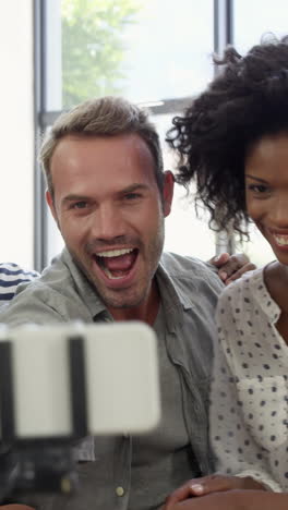 Multi-ethnic-friends-smiling-and-taking-selfie