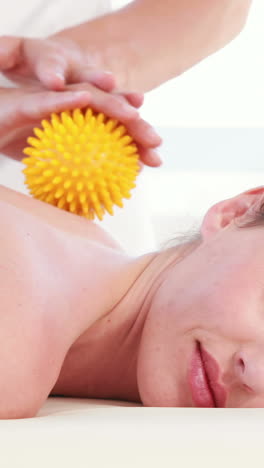 Woan-having-back-massage-with-massage-ball