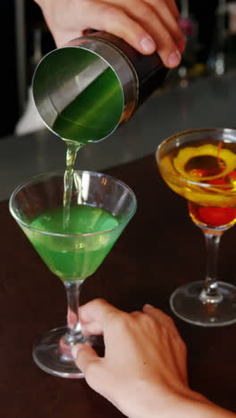 Close-up-of-barman-is-serving-a-cocktail-to-woman