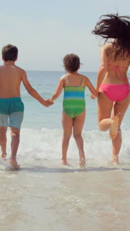 Happy-family-running-towards-waves