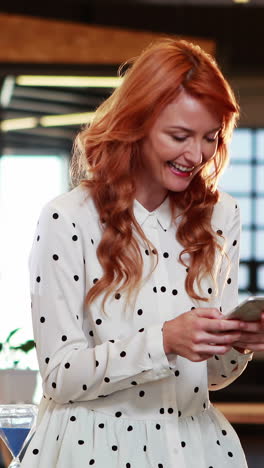 Businesswoman-text-messaging-on-mobile-phone