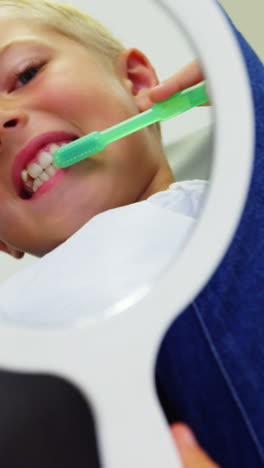 Dentist-brushing-a-young-patients-teeth