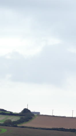 Wind-turbine-revolving-over-farmland