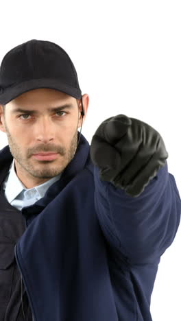 Security-guard-standing-and-pointing-on-white-background