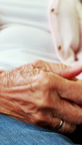 Extreme-close-up-view-of-retired-person-rubbing-her-hands-together