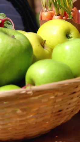 Close-up-of-harvested-fruits-and-vegetable-in-wicker-basket-in-field