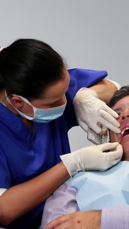 Dentista-Comparando-Tonos-De-Blanco-Con-Los-Dientes-De-Los-Pacientes