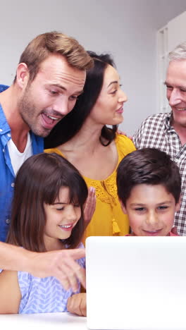 Happy-family-doing-video-chat-on-laptop