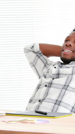 Casual-businessman-relaxing-in-his-swivel-chair