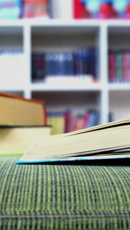 An-open-book-on-sofa-in-library-at-school