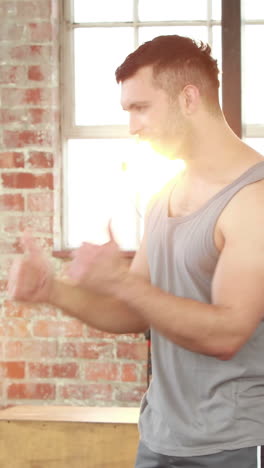 Fit-couple-high-fiving-in-crossfit-gym