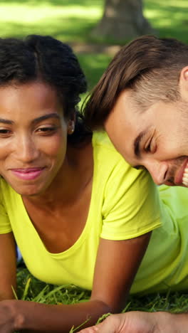 Smiling-friends-chatting-and-lying-on-the-grass