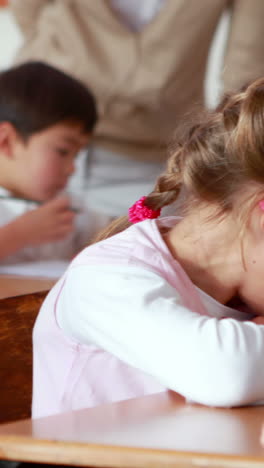 Schoolchildren-colouring-in-books-in-classroom