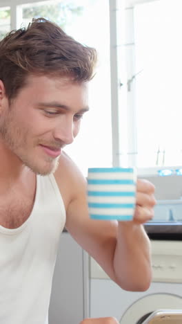 Man-having-coffee-and-using-smartphone