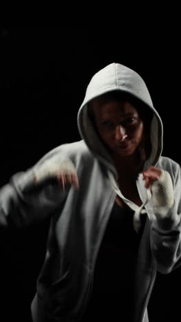 Muscular-woman-with-grey-hood-boxing