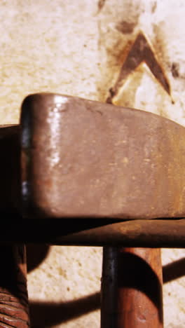 Close-up-of-various-hammers-at-workshop