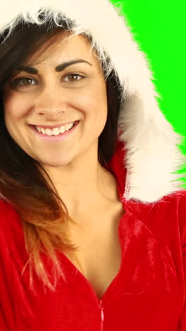 Pretty-brunette-in-santa-hat-blowing-over-hands