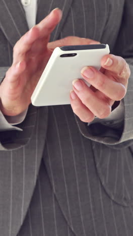 Close-up-of-businesswoman-using-smartphone