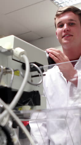 Young-science-student-looking-through-high-powered-microscope