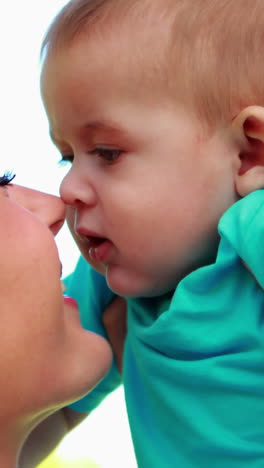 Happy-mother-rubbing-noses-with-cute-baby-son-in-the-park