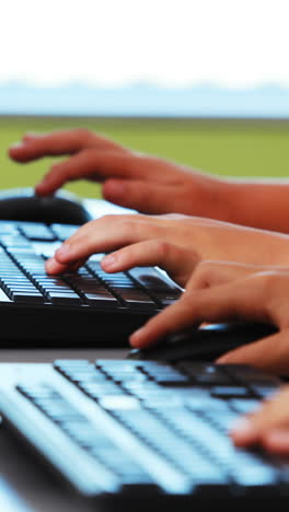 Schoolgirls-using-computer-in-classroom