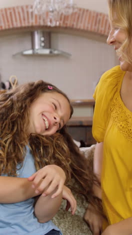 Parents-talking-with-their-daughter-on-couch