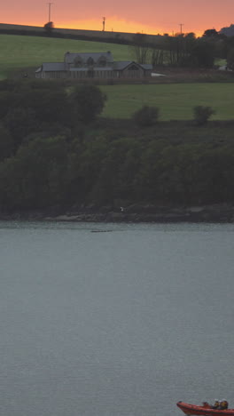 Fishing-boat-sailing-early-in-the-morning-with-the-sunrise-in-the-background