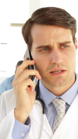 Handsome-doctor-talking-on-the-phone