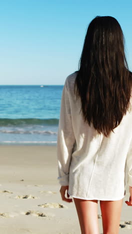 Woman-walking-on-beach