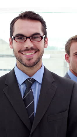 Smiling-business-team-posing-for-camera