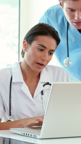 Medical-team-working-on-laptop-computer-